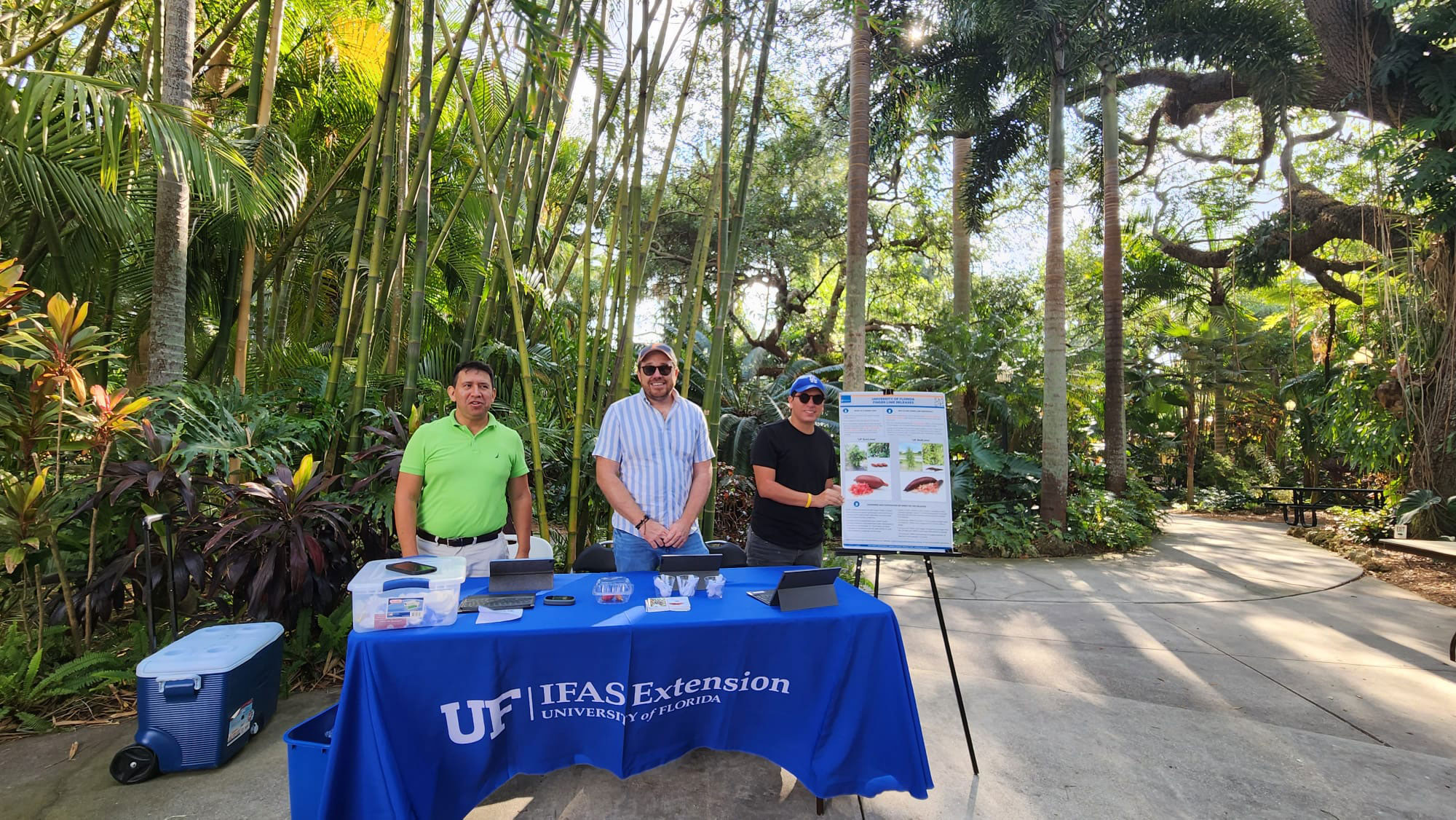 Three men standing with Finger lime display